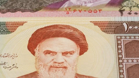 Iran rial banknotes slow tracking. Iranian currency. Slider shot, low angle. 4K Stock Footage 125999246