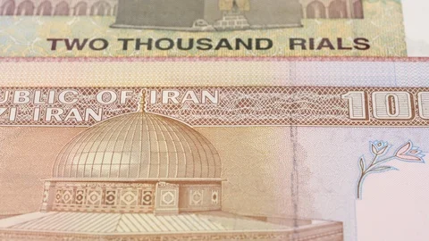 Iran rial notes slow tracking. Iranian money. Slider shot, low angle. 4K Stock Footage 125999617