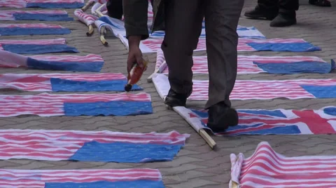 Iran, sprinkling liquid fuel on American and British flags, protest Stock Footage