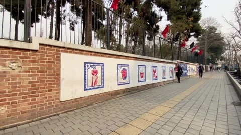 Iran, Tehran, People Walk Past Former Us Embassy Compound Stock Footage 267014432