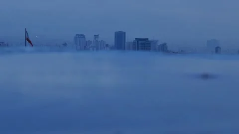 Iranian flag over rainy Tehran skyline with raindrops on blurred surface Stock Footage 317836971