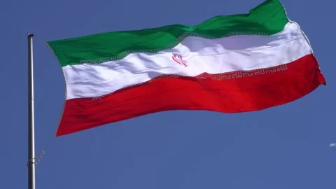 Iranian Flag rippling in front of a blue sky Stock Footage 335882758