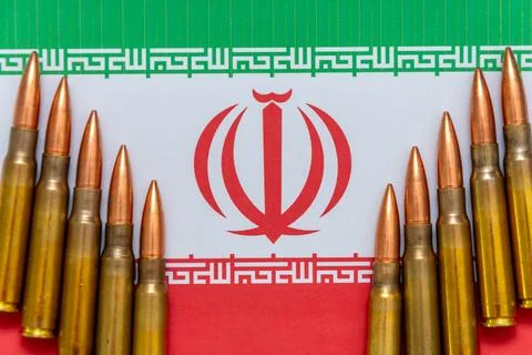 The Iranian flag is surrounded by live bullets, a symbol of political tension Stock-Fotos