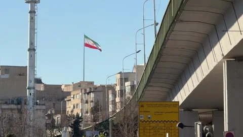 Iranian flag waving over the cityscape Stock Footage 335940841