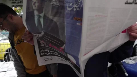 Iranian newspapers react to the fall of Al-Assad and the situation in Syria, Teh Video stock 295036439