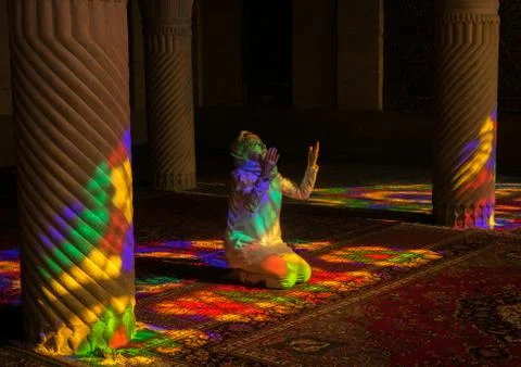 Iranian Woman Praying In The Nasir Ol Molk Mosque With Its Beautiful Coloured Stock Photos