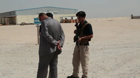 Iraqis Talking in Foreground of SKA Terminal Video stock 42955800