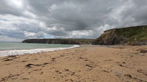 Ireland epic locations long beach with people walking rain clouds approaching Stock Footage 339009731