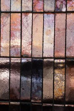 Iridescent copper ceramic tiles creating an abstract pattern wall Stock Photos