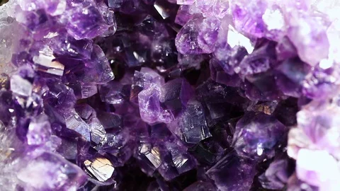 Iridescent light on an amethyst druzy stone. Macro footage. Stock Footage 129570828