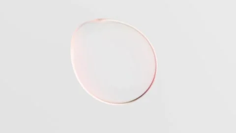 Iridescent liquid glass bubble morphing and changing shape on a white background Stock Footage 347882872