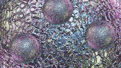 Iridescent sphere with rolling small Christmas spheres looping 3D animation Stock Footage 185458990