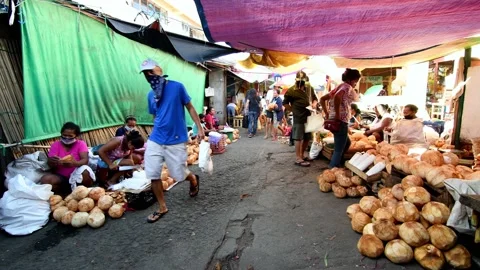 Iriga City, Philippines- 5/14/2: Local Filipino coconut vendor at market Stock Footage