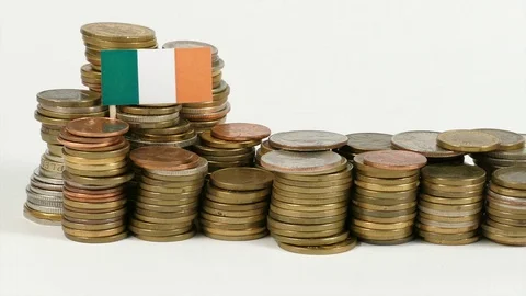Irish flag waving with stack of money coins Stock Footage 71939989