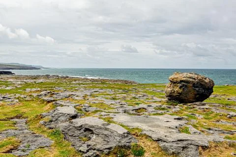 Irish landscape of a giant stone with the sea in the background in the Burren Stock Photos