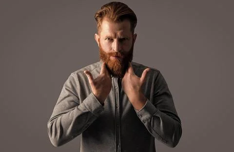 Irish man touching beard. Bearded man with stylish beard and mustache. Handsome Stock Photos