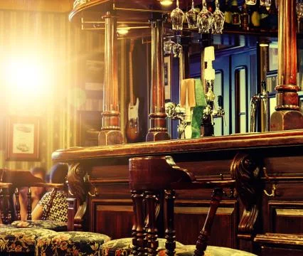 Irish pub interior tiled floor. evening bright light, classic design Stock Photos