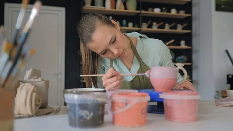 Irl in pottery studio making ceramic products from white clay Stock Footage 119545714