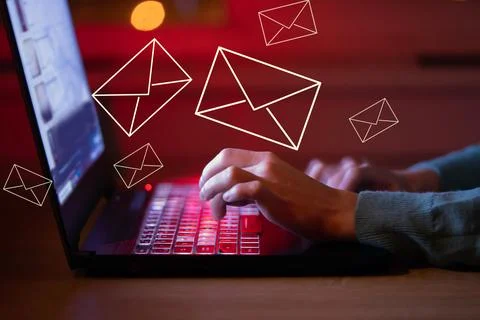 Irl sends letters, emails using her laptop, hands on keyboard closeup. Stock Photos
