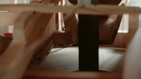 An iron beam inside a windmill shakes grain to be pulvered to wheat Stock Footage 85214435