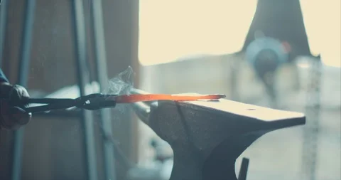 Iron being hammered on an anvil by a blacksmith Stock Footage 105305359