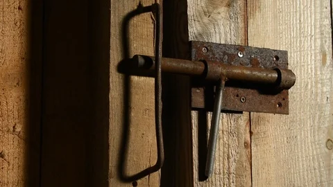 Iron bolt on a rough door Stock Footage 122009898