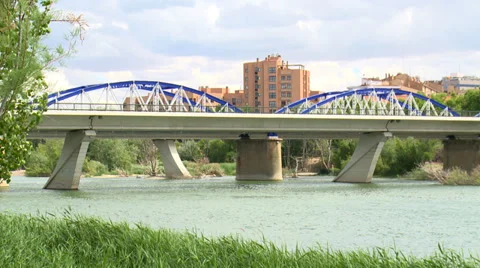Iron bridge and cloudscape over river Ebro Stock Footage 38703579