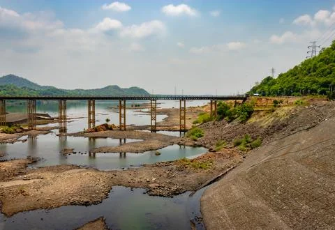 Iron bridge over river with a cloudscape in the background Stock Photos