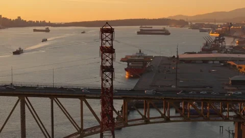 Iron bridge at sunset with moving traffic with harbour in the background Stock Footage 254501982