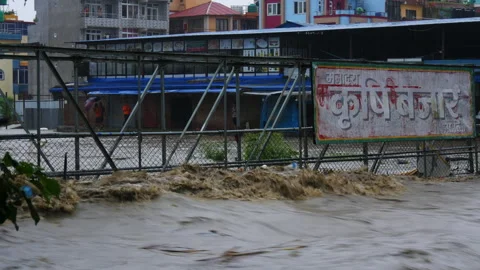 Iron bridge to vegetable market getting smashed by muddy and polluted flood Stock Footage 286015834