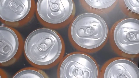 Iron cans in polyethylene packaging with carbonated drink Stock Footage 312005863