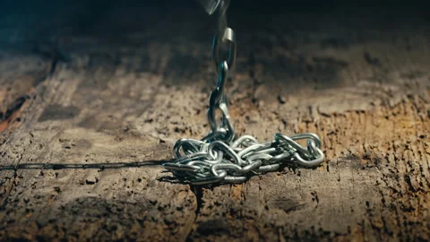 Iron chain falling down into an aged wooden floor. Stock Footage 170489965