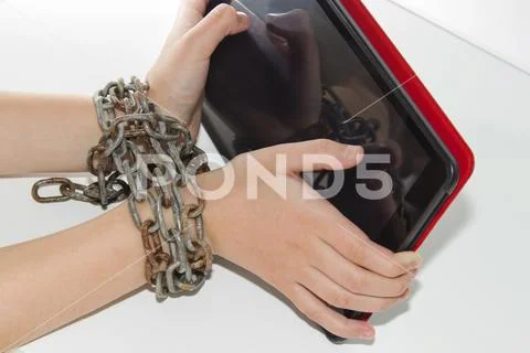 Iron chain ties together hands and smartphone - mobile phone addiction concep Stock Photos