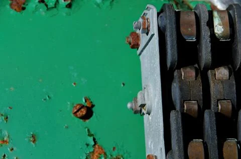 Iron components on green rusty background whit screws. Stock Photos