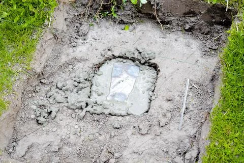 Iron construction in cement solution, slurry, concrete mortar in ground. Pr.. Stock Photos