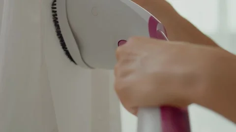 Iron delicate fabrics with a steamer for perfect results every time Stockbeeldmateriaal 324648329