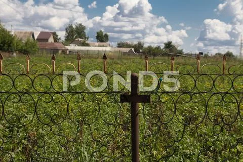 Iron fence and a blue sky with clouds Stock Photos