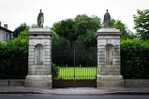 Iron gate between two stone towers Stock Photos