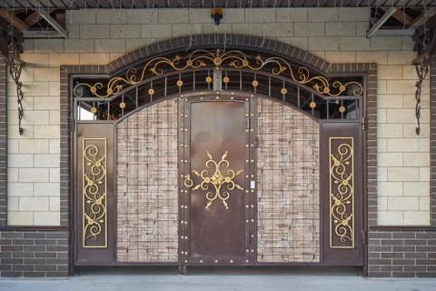 Iron gates with decorative elements and profiled sheet inserts Stock Photos