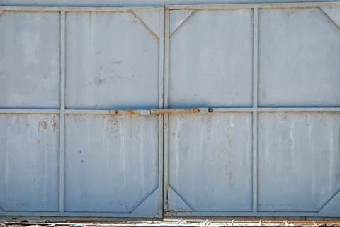 Iron gates. Old gray back gate. For background Stock Photos