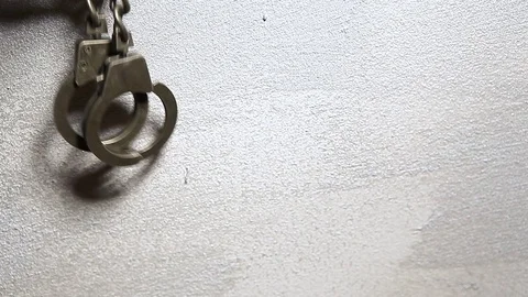 Iron handcuffs sharp wall background hd footage Stock Footage 124661546