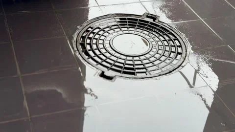 A iron hatch with a pattern and covered water above an observation well is Stock Footage 274418148