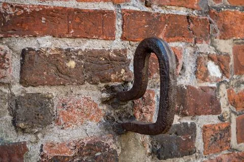 Iron hooks in a brick wall Stock Photos