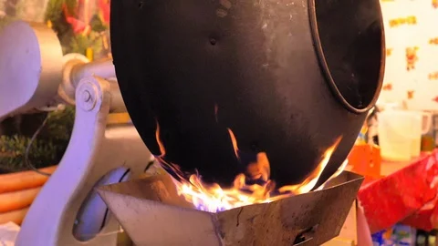 Iron kettle on fire flame to confit caramelize Christmas sweets Stock Footage 124477576