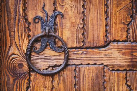 Iron knocker or ring handle on old wooden door Stock Photos