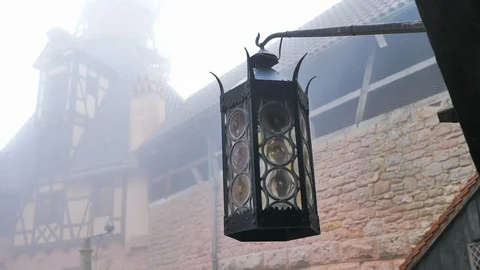 Iron lantern moved by icy wind in fog-covered horror castle Stock Footage 124481994