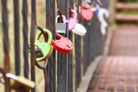 Iron lock on the railing of the bridge close-up. Stock Photos