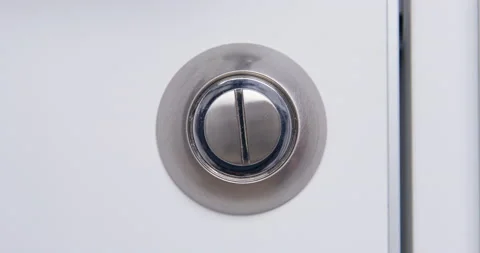Iron lock on white door opens and closes by rotation at home Stockbeeldmateriaal 174988706