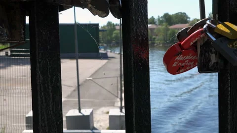 Iron locks, bonded the bride and groom on the bridge Stock Footage 99538201