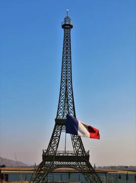 Iron model of the eiffel tower with the flag of france Stock Photos